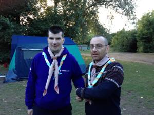 Michael is welcomed into the 1st Gilwell Park Scout Group by his friend Peter.